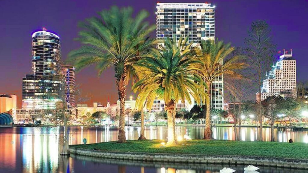 Nighttime cityscape of downtown Lake Worth Beach, Florida, with palm trees and waterfront views near Lake Worth Beach bail bonds offices.
